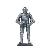 A pewter-plated metal knight in armour figurine, standing on a square base.