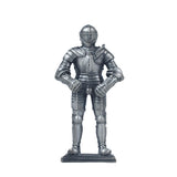 A pewter-plated metal knight in armour figurine, standing on a square base.