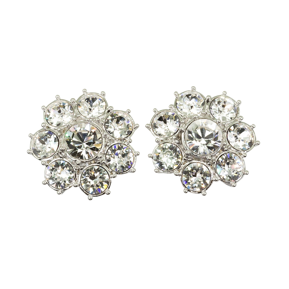 A pair of silver-colored floret-shaped stud earrings embellished with clear crystals.