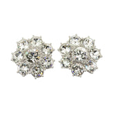 A pair of silver-colored floret-shaped stud earrings embellished with clear crystals.