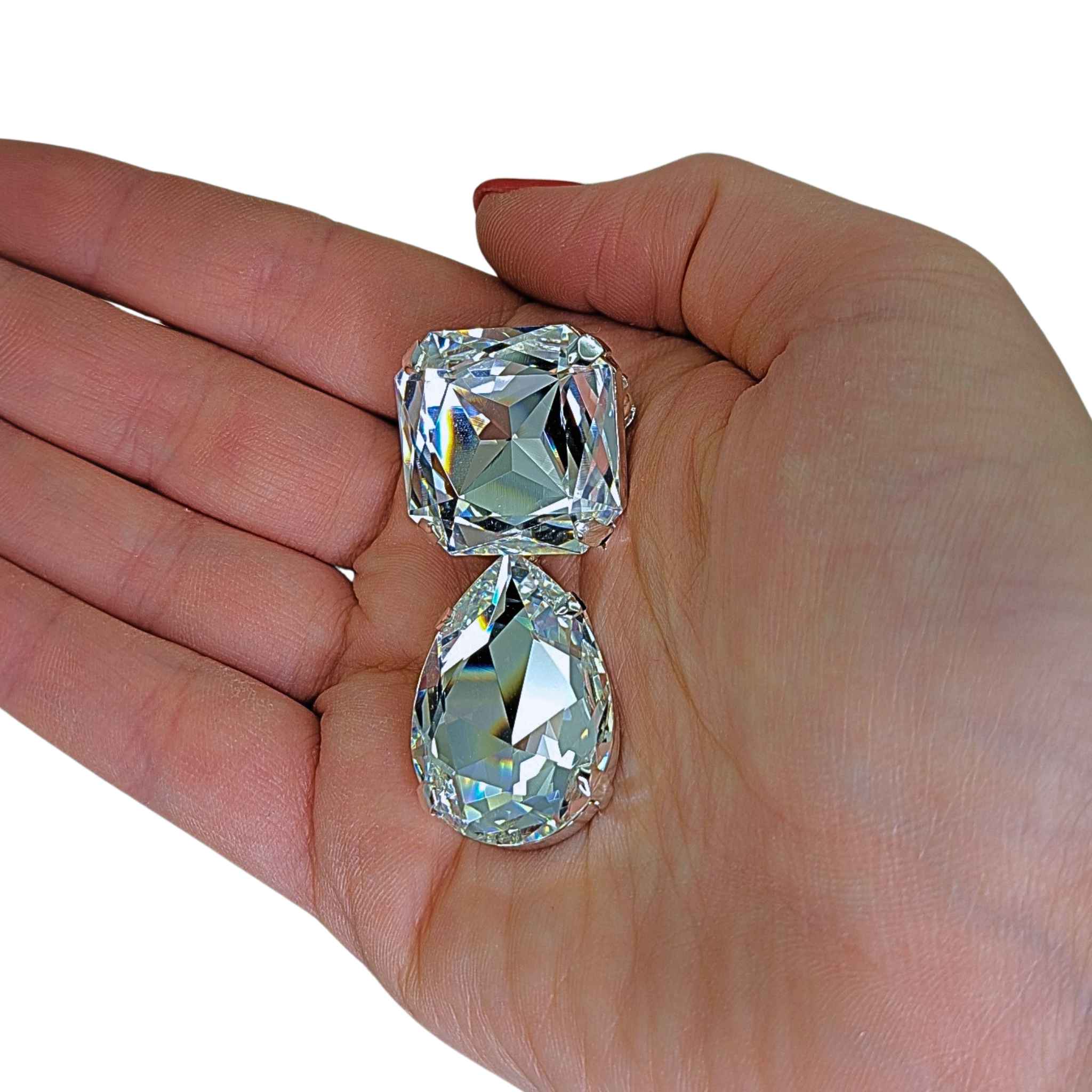 The Cullinan Diamond III & IV Brooch held in hand to show scale