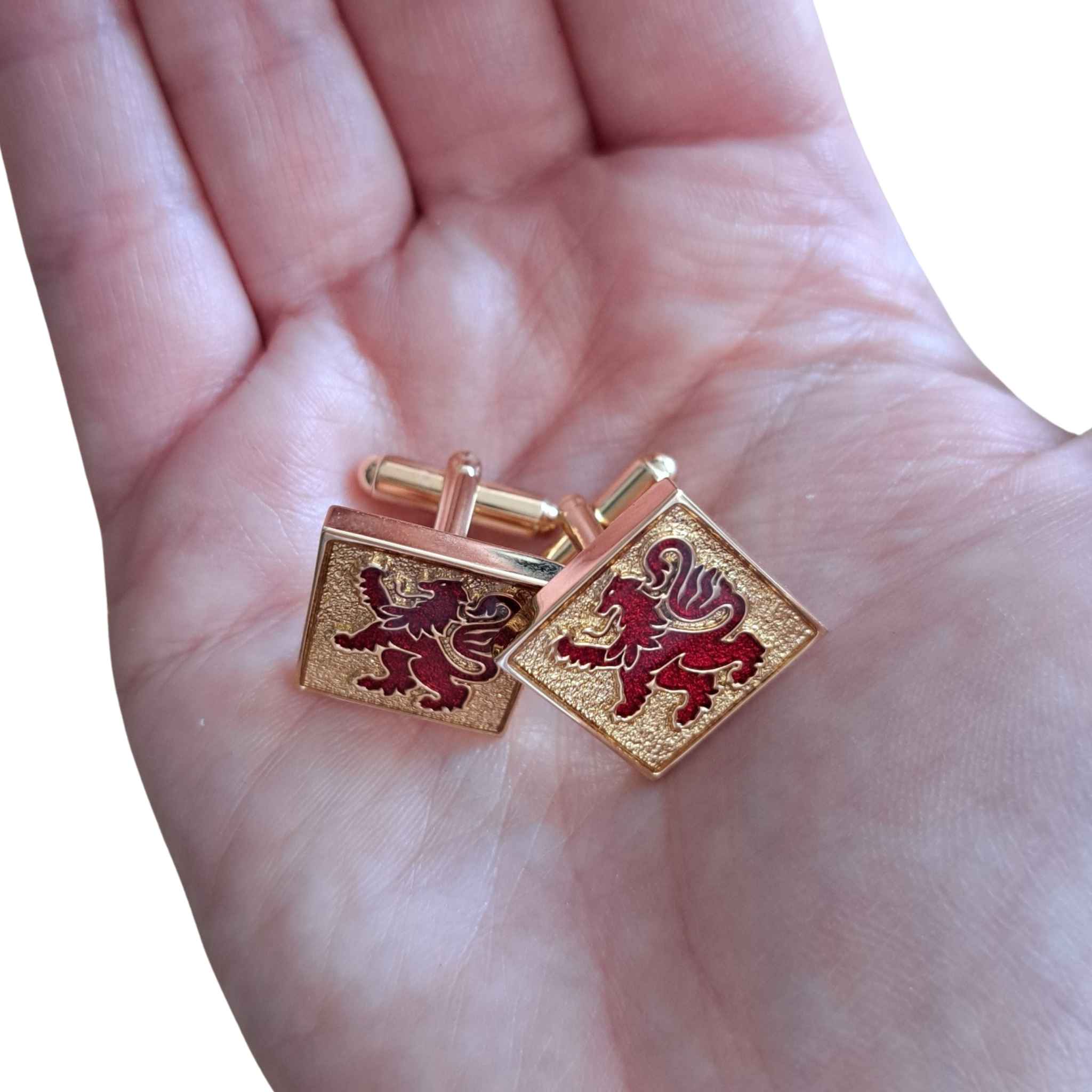 Lion Rampant Red and Gold Cufflinks pictured in palm of a hand for scale