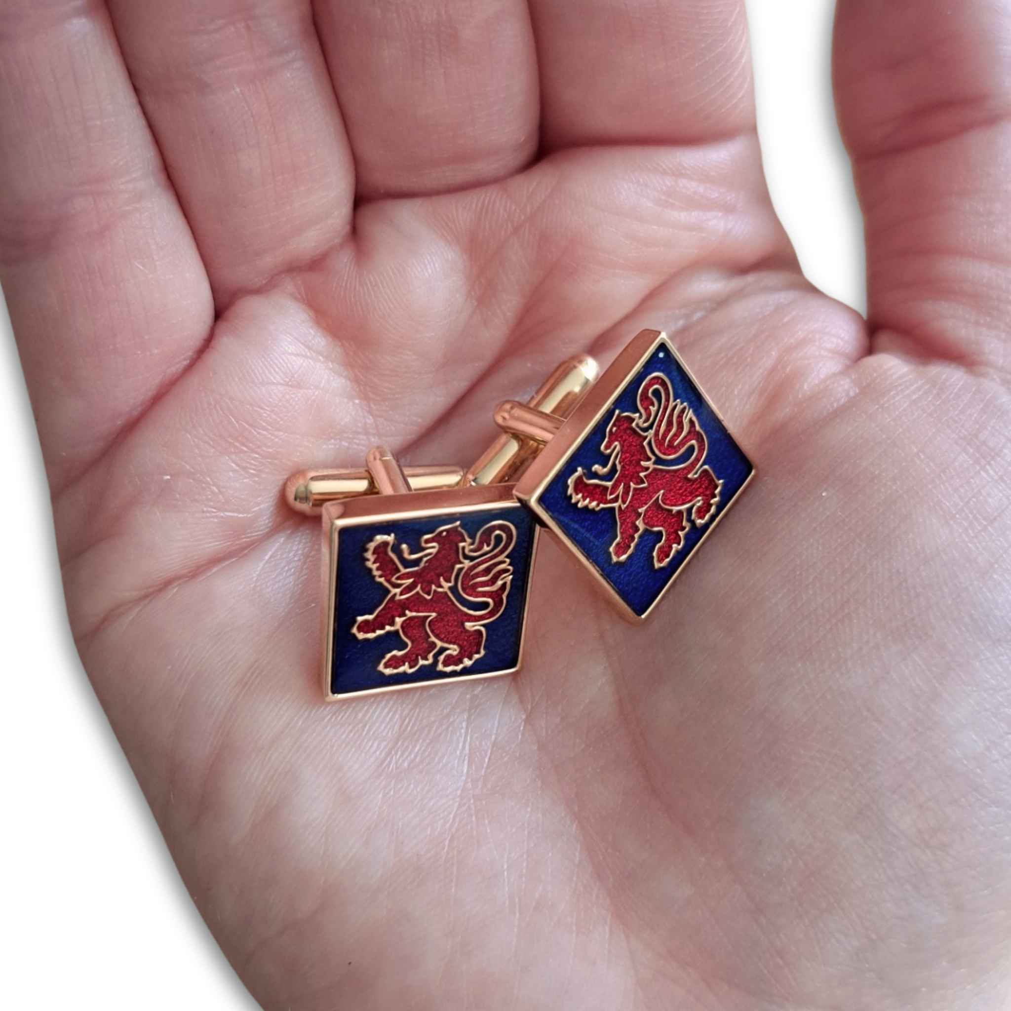 Lion Rampant Red and Blue Cufflinks in hand for scale