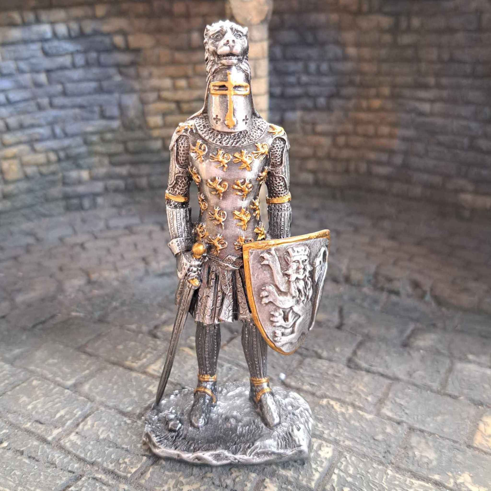 Metal knight with lion crested helmet close up