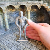 Metal Knight in armour 2 pictured with hand for scale